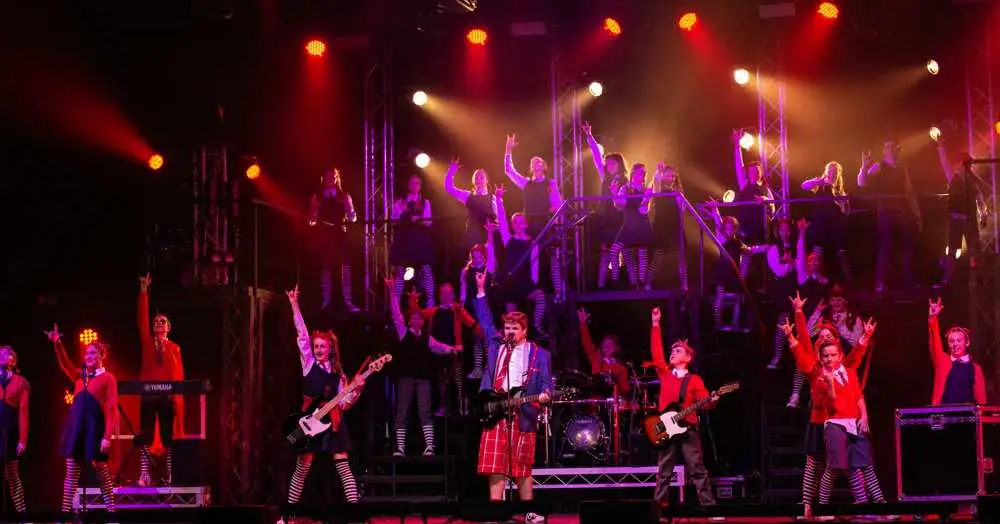 The School of Rock band rocking out on stage