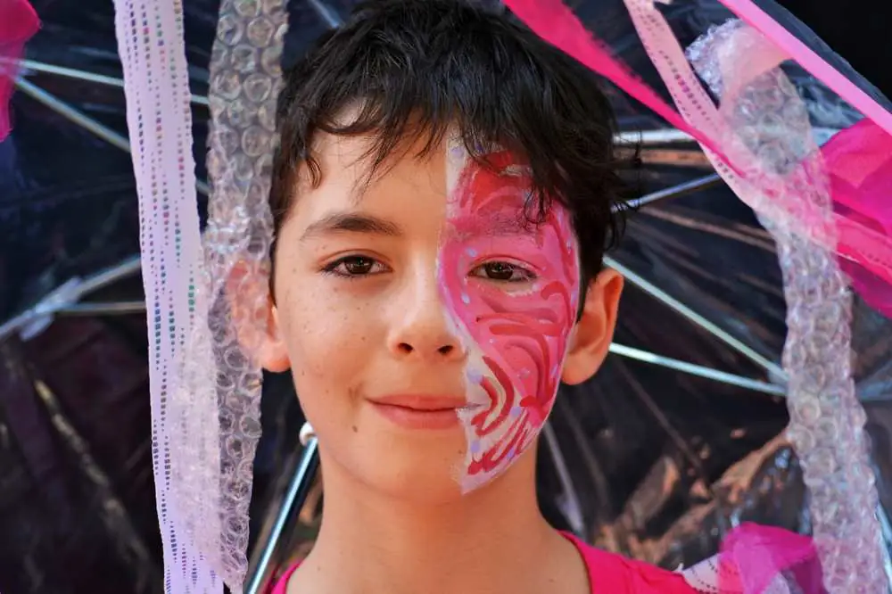 A young performer with face paint