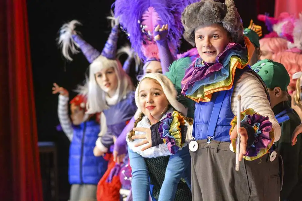 Young performers in colourful fancy-dress costumes