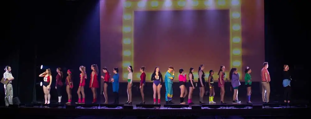 A line of dancers waiting to audition in 80s leotards
