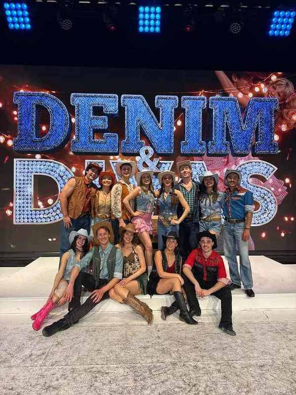 The Denim and Divas cast in front of the show logo