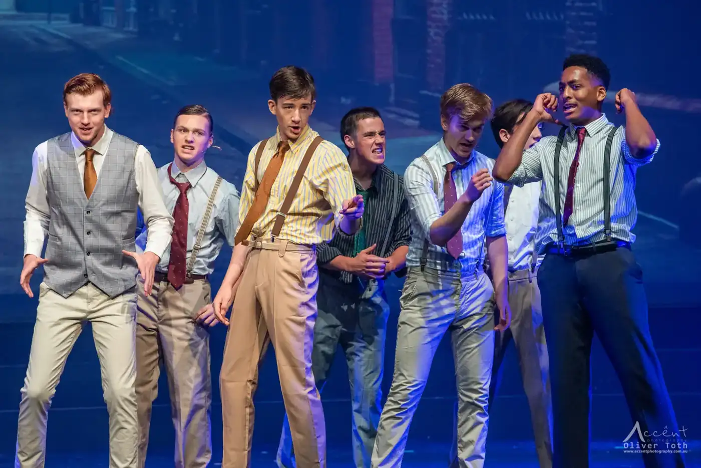Teen performers in suspenders and ties mid-number