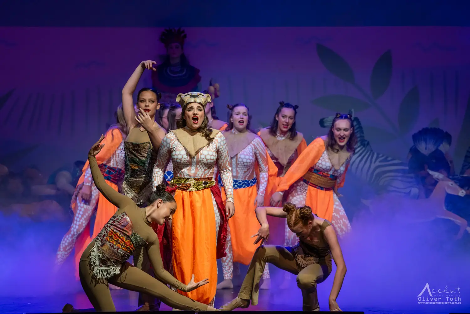 Performers in orange costumes and lion masks