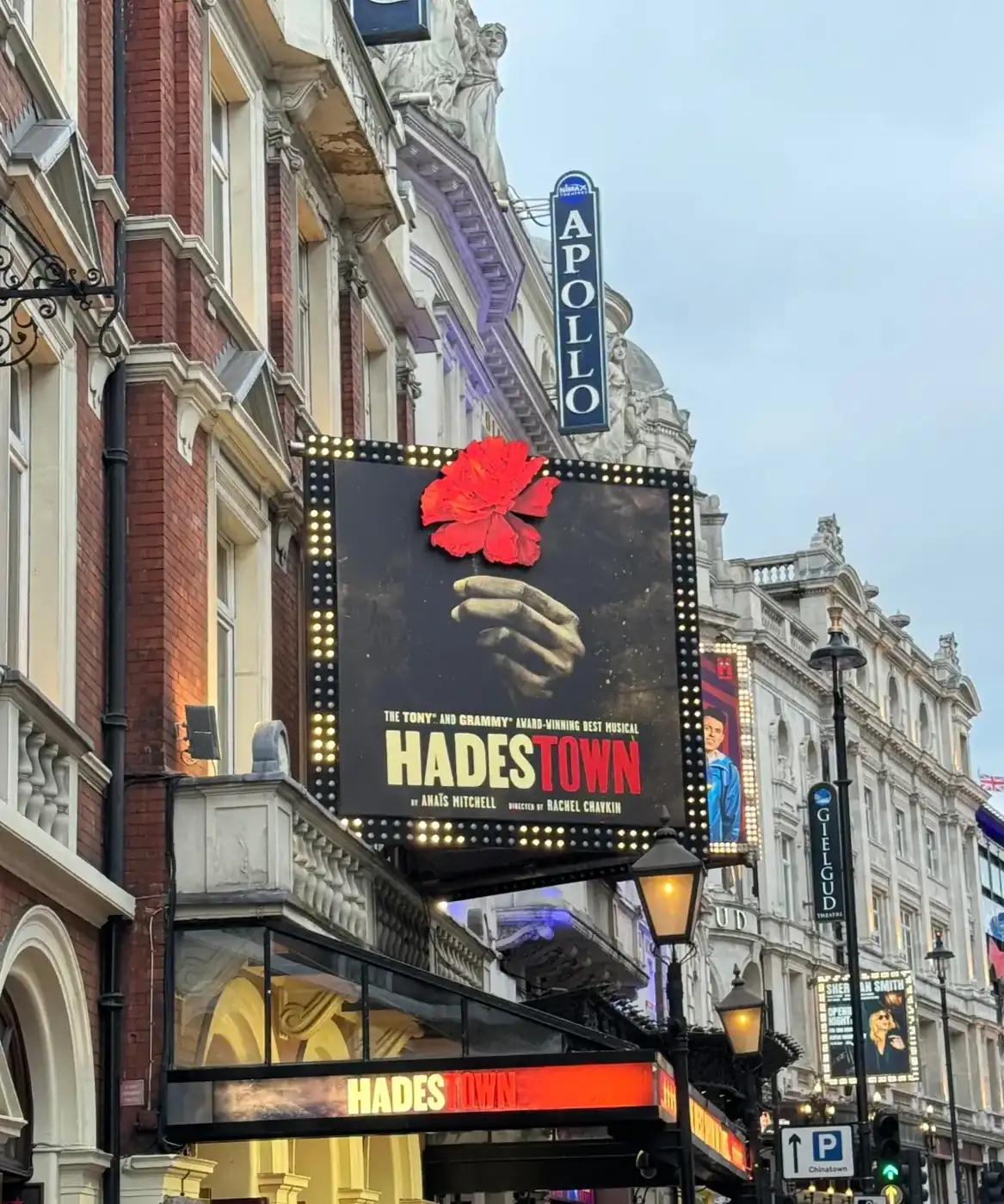 The Hadestown sign on Shaftesbury Avenue in London’s West End, with the Apollo and Gielgud theatres beside it